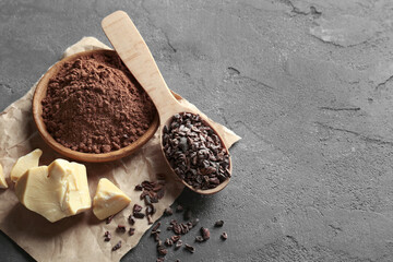 Composition with cocoa nibs, butter and powder on gray background