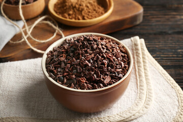 Bowl with cocoa nibs on table