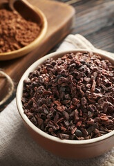Bowl with cocoa nibs on table