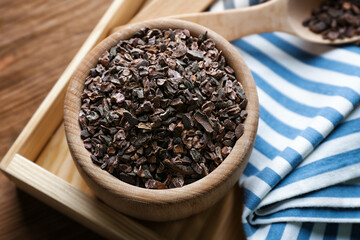 Composition with cocoa nibs on wooden table