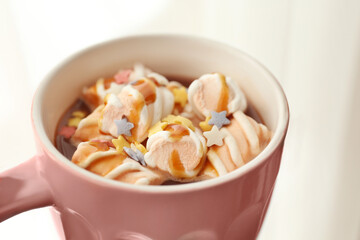 Cup of tasty cocoa with marshmallow on light background, closeup