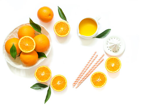 Orange juice and oranges isolated on white background top view.