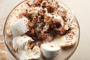 Cup of tasty cocoa drink with marshmallow on light background, closeup