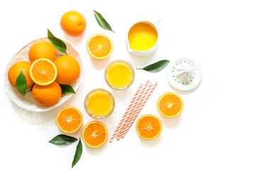 Orange juice and oranges isolated on white background top view.