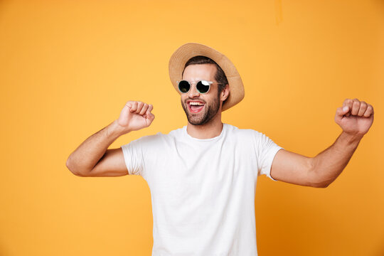 Emotional man in summer hat looking aside isolated dancing.