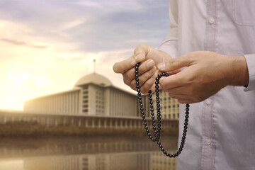 Hand of asian muslim man with prayer beads praying