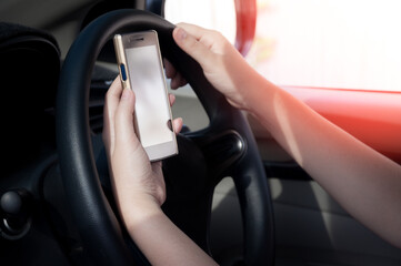 Woman using a smartphone while driving a car between driving because addict social media