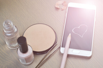 Morning routine background with Phone, rouge, shadows on the table