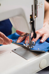Sewing workshop. Sewing zipper on sewing machine.