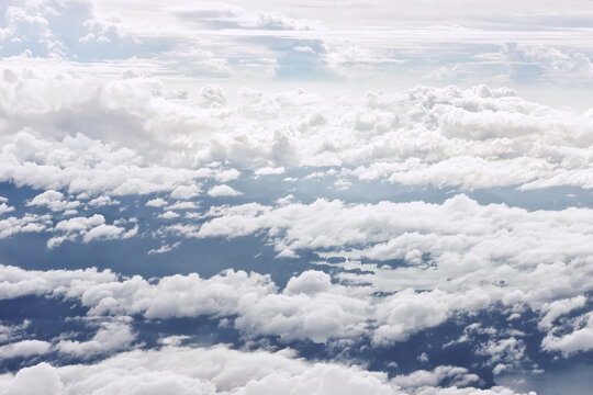 Beautiful fluffy clouds background, top view. Text space
