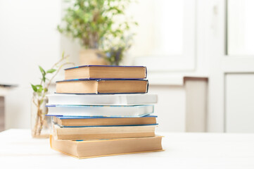 A stack of books on a white table