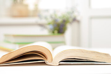 Open book on white table