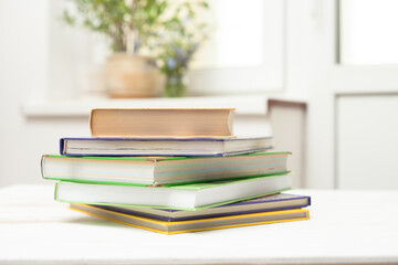 A stack of books on a white table