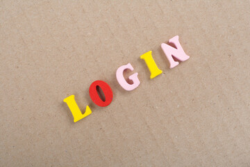 LOGIN word on wooden background composed from colorful abc alphabet block wooden letters, copy space for ad text. Learning english concept.