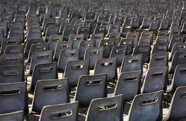 Empty chairs in a row in St Peters Square , Vatican City