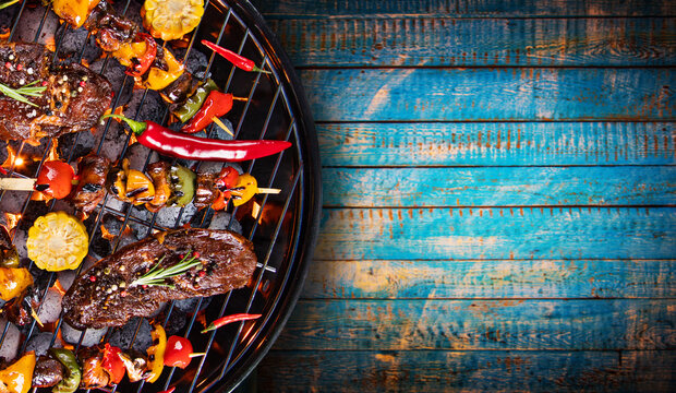 Barbecue grill with beef steaks, close-up.