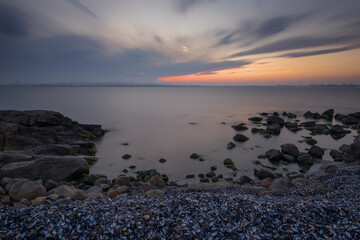 Magnificent cloudy sunset over the sea. Spring sunset, landscape, seascape.