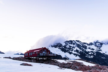Mueller Hut during the sunset at the top of a snowy mountain of mount cook national park in the south island of new zealand