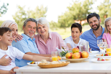 Extended family eating outdoors
