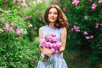 Young girl stand at park background with bouquet of flowers