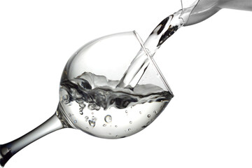 Water pours into a glass on a white background, monochrome image