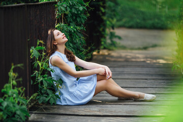 Girl pose to camera at park background with her dress