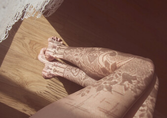 Floral shadow pattern on female legs
