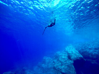 spearfishing in the blue sea water