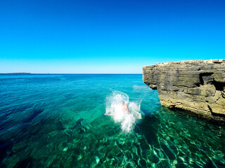 happy boy jumping in the croatian sea