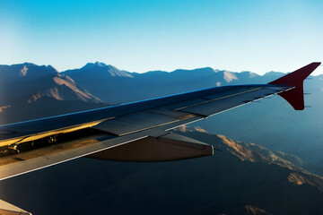 Obraz premium View from airplane window. Wing of an airplane flying above the clouds.