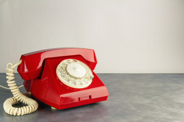 Red retro phone standing on a table