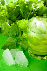 A glass of lemonade with lime and mint