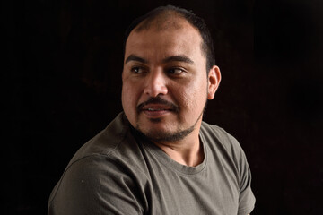 Fototapeta premium Portrait of a latin man on black background