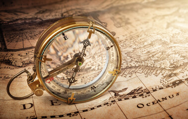 Old compass on vintage map. Retro style.