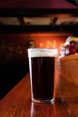 Glass of fresh beer on pub table