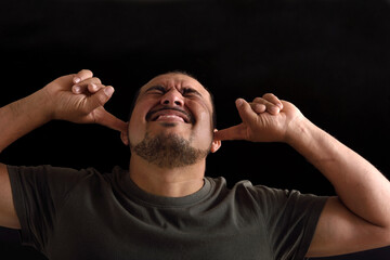 Portrait of a latin man with noise on black background