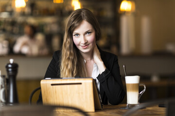 young business woman working at cafe at break