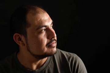 Portrait of a latin man on black background