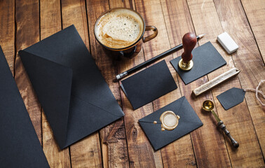 Set of black stationery elements on vintage wood table background. Branding template Photo of blank stationery. Mock-up for your design.