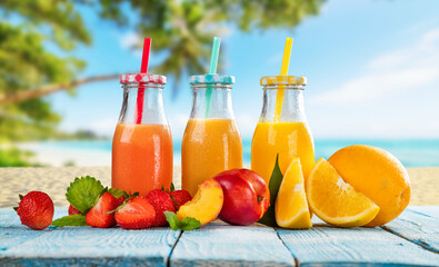 Fresh smoothie drinks placed on wooden planks, blur beach on background
