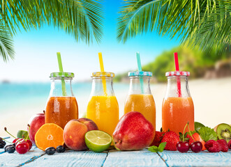 Fresh smoothie drinks placed on wooden planks, blur beach on background