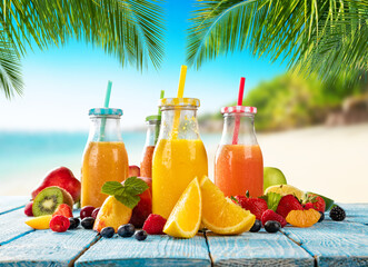 Fresh smoothie drinks placed on wooden planks, blur beach on background