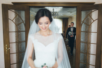 The groom goes to his bride in the room