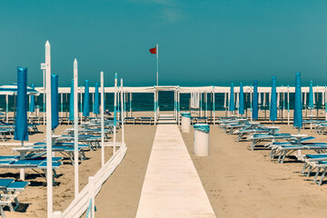 sand beach with chaise longue and umbrellas Riccione, rimini, italy - obrazy, fototapety, plakaty