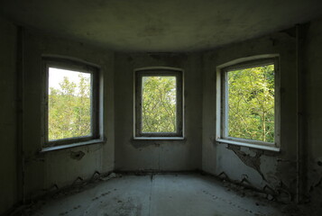 Three windows in an old and ruined building