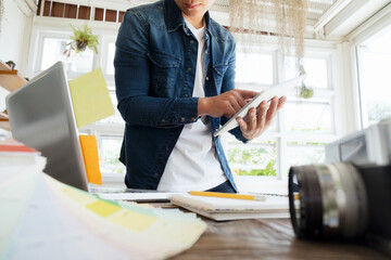 Freelance Photographer using table and computer select pictures.