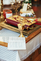 Golden accessories stand on the table in church