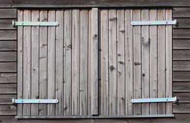 Wall made from wooden laths with a hatch