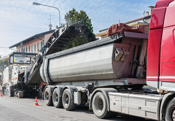 Tipper truck used in work of asphalting. - obrazy, fototapety, plakaty