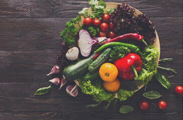 Plenty of fresh vegetables on wooden background with copy space